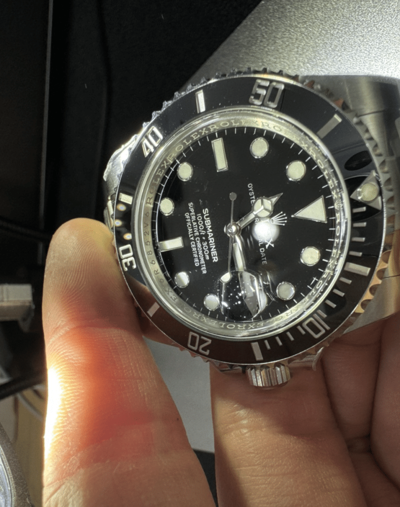 A close-up view of the side structure of a replica Submariner 116610.