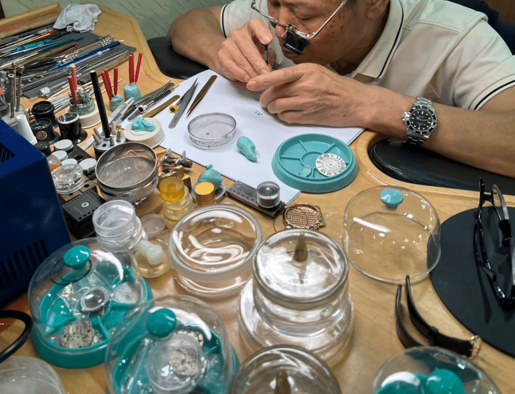 The watchmaker is repairing a superclone watch.