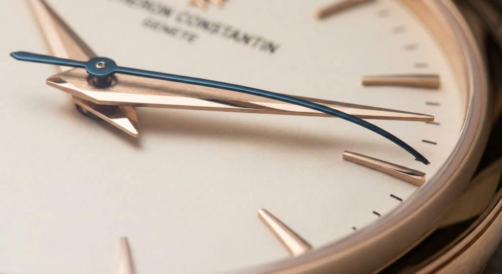 A macro view of the Dauphine hands on the Patrimony 85180 shows the contrasting polished and brushed surfaces and the downward curvature of the second hand towards the dial edge.