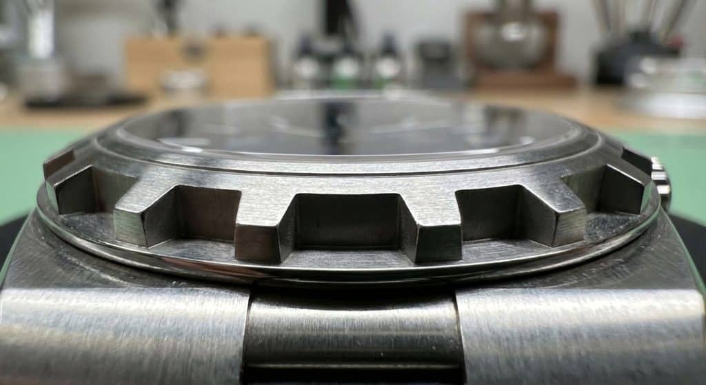 The hexagonal Maltese Cross bezel of the Vacheron Constantin Overseas is captured at a 45-degree angle, highlighting the depth of the shadow-lines in the notches.