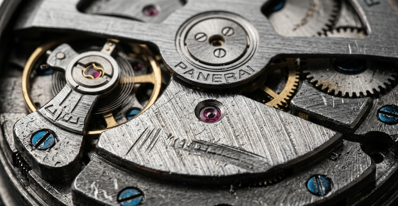 Close-up macro photo of a replica watch movement showing rough finishing and visible machine marks on bridges