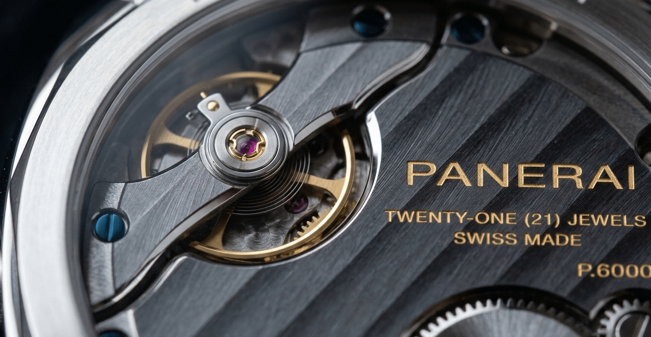 Macro shot of a genuine watch movement bridge showing sharp, consistent anglage and deep Côtes de Genève stripes