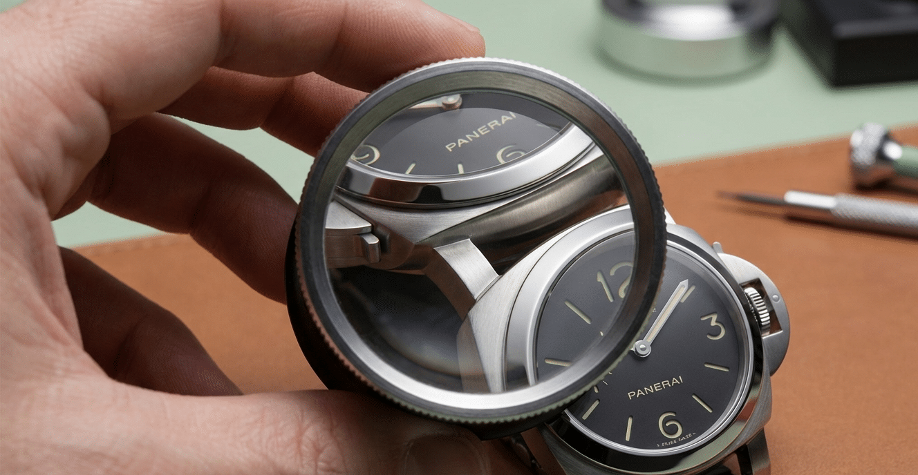 A loupe magnifying the lug-to-case integration point of a Panerai replica, highlighting the curvature and finish.