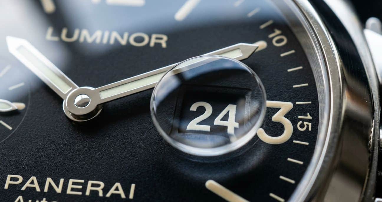 Macro photo of a Panerai date window with a cyclops, showing the date numeral, font, and magnification effect.