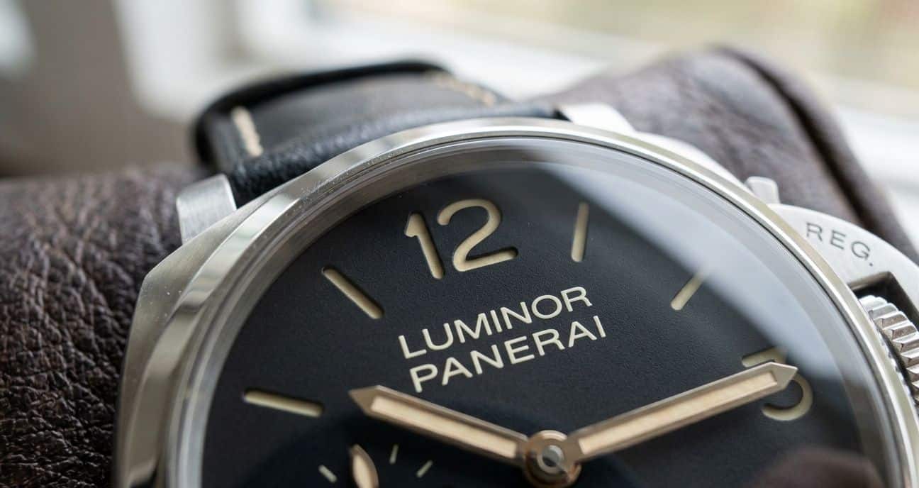 A close-up of a Panerai replica watch dial with a magnified view of the "Luminor Panerai" text, showing crisp printing and lume application.