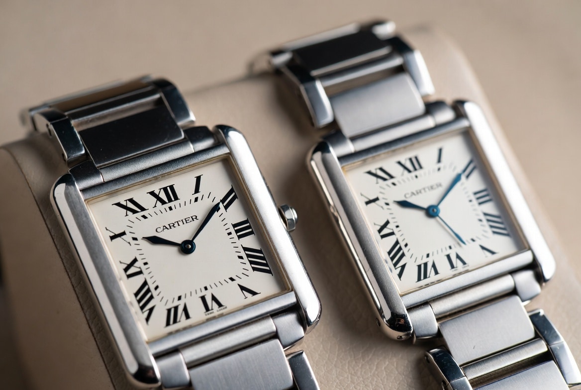 A side-by-side comparison of a genuine Cartier Tank watch and a replica, highlighting subtle differences in case finishing.