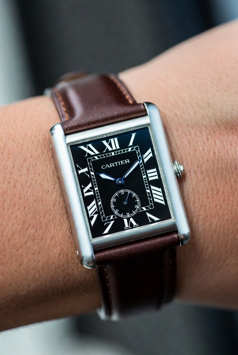 Cartier Tank Must replica with a slender profile, showcasing its elegant thinness on a wrist.
