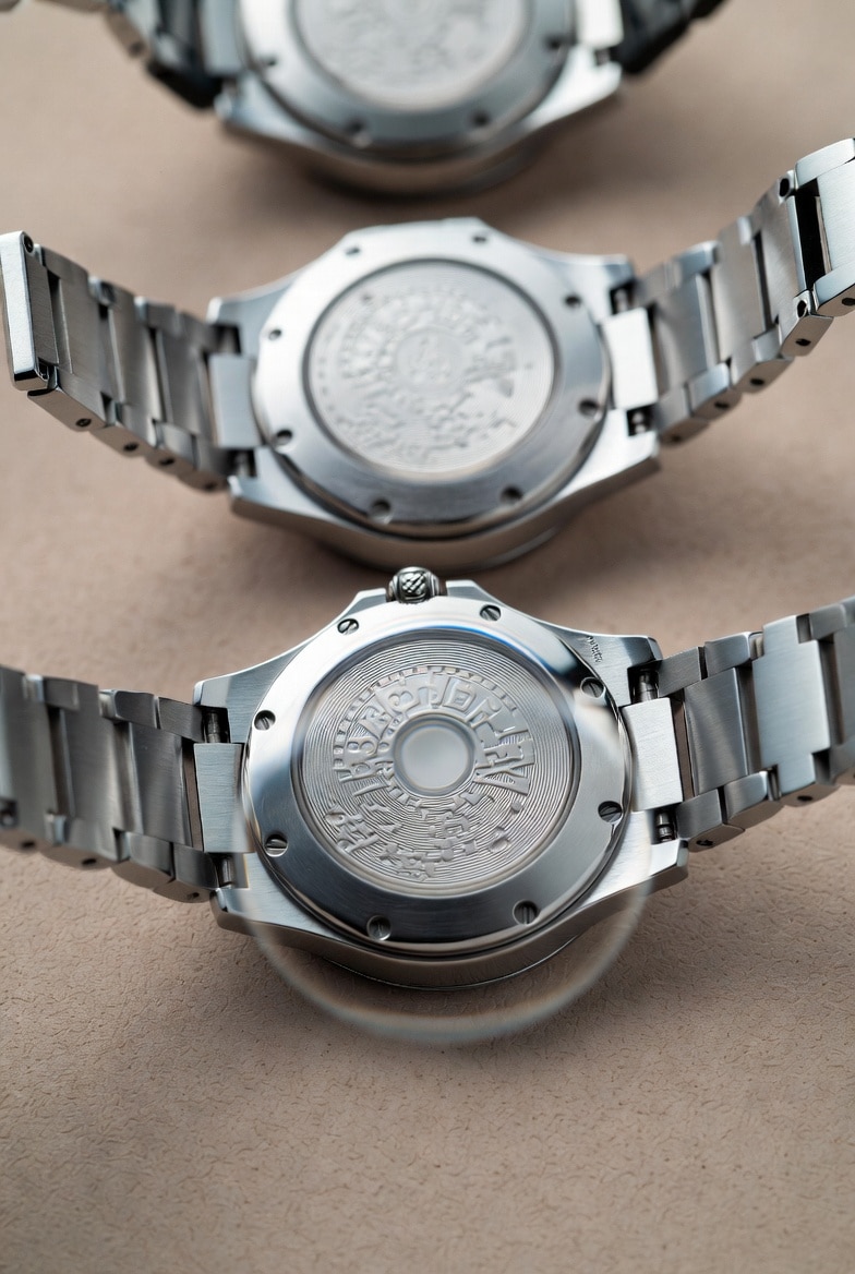 A magnified view of a replica watch caseback engraving, showing blurry lines and inconsistent depth compared to a sharp, genuine engraving.