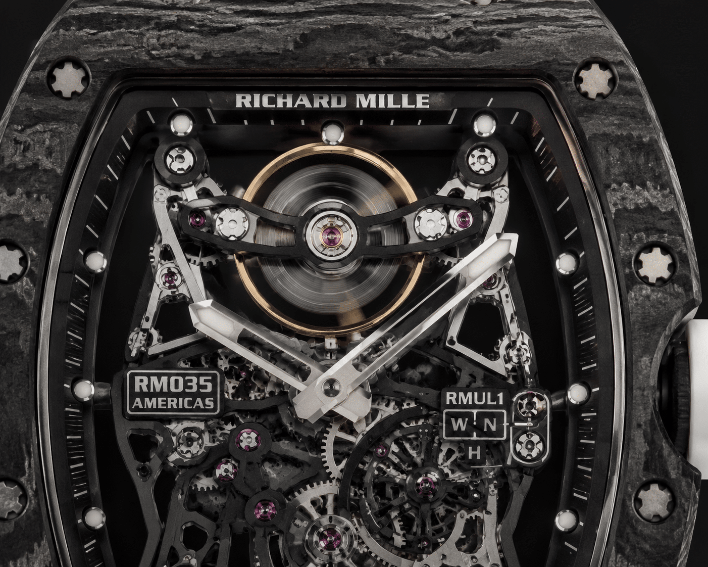 close-up view of a Richard Mille replica dial showing the balance wheel position at 12 o’clock, with visible oscillation blur under neutral lighting