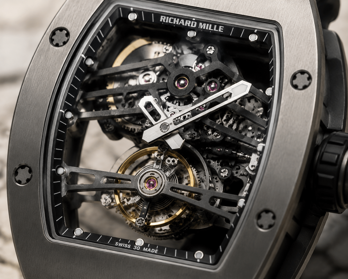 close-up of a replica tourbillon cage in a Richard Mille case, showing bridge layout and balance wheel exposure under natural light