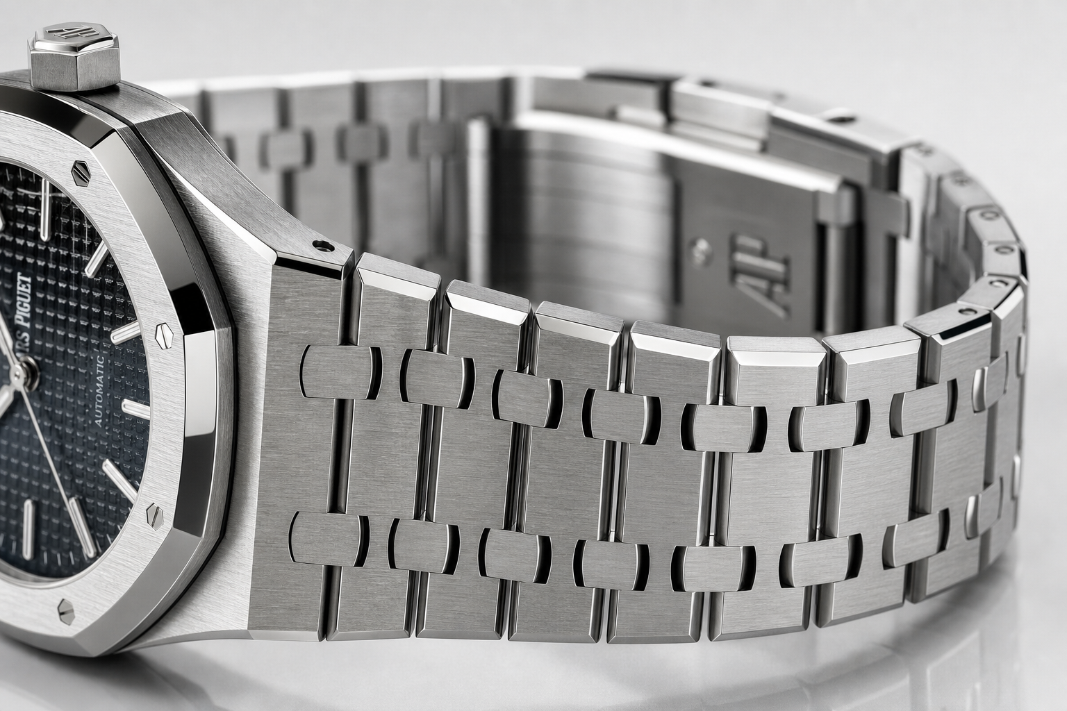 close-up of Audemars Piguet-style integrated bracelet showing link articulation, brushed surfaces, polished bevels, and clasp fit