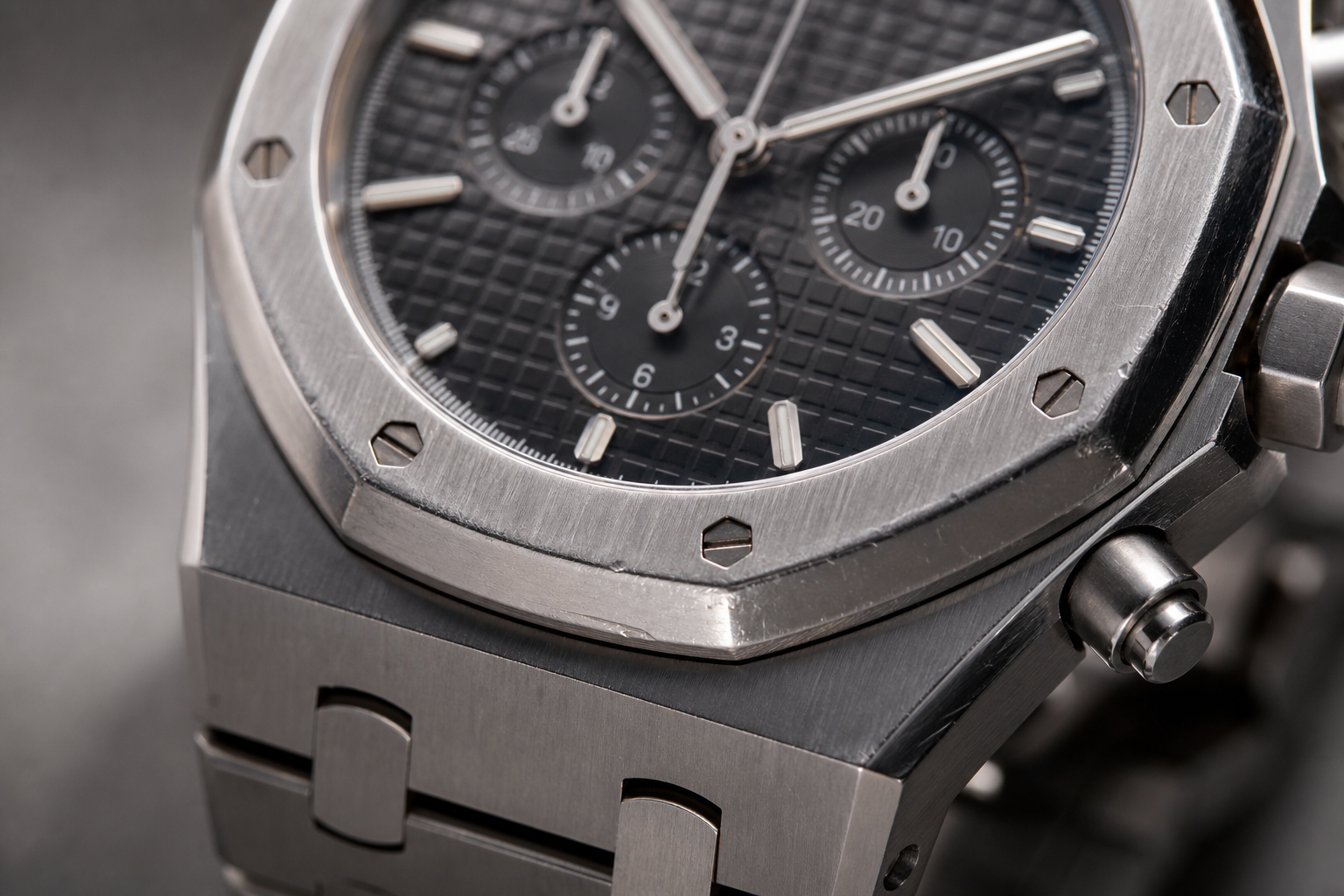 close-up of AP-style replica bezel and brushed case surfaces showing areas where scratches and edge wear are most noticeable