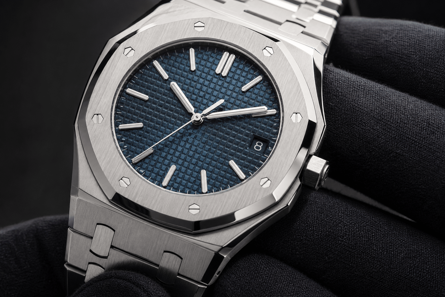 close-up AP Royal Oak replica inspection showing tapisserie dial texture, date window alignment, bezel screws, polished bevels, and bracelet link finishing