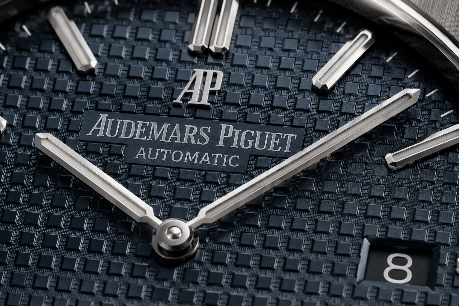 close-up AP Royal Oak replica dial texture showing square pattern depth, applied markers, and light reflection under neutral lighting