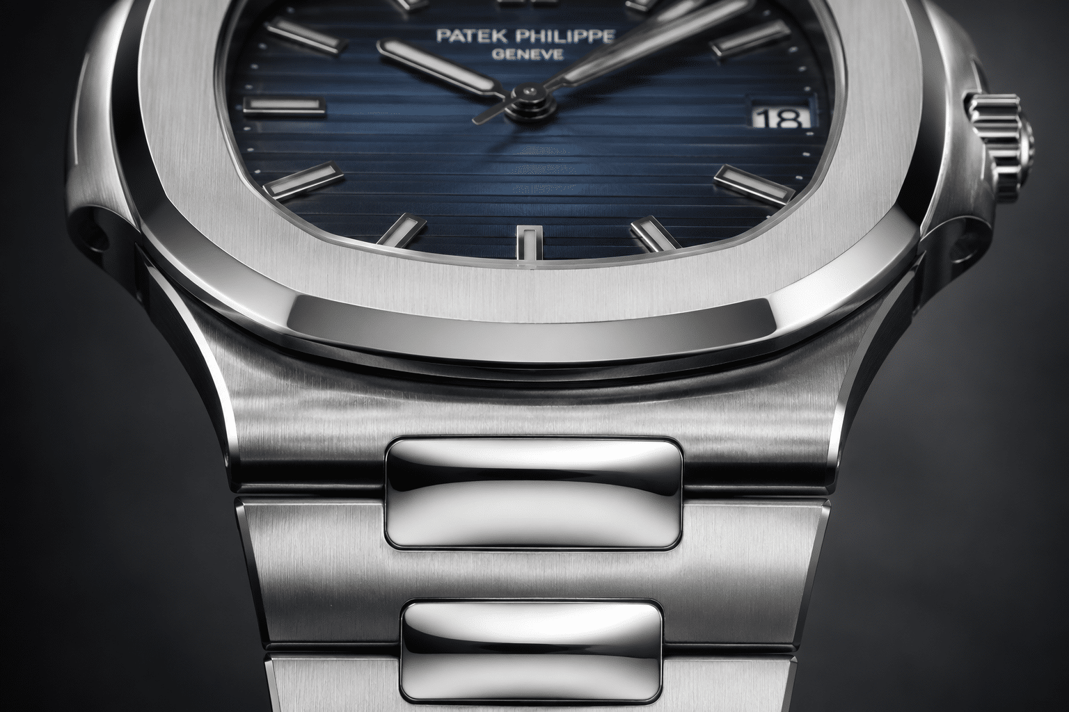 close-up of Nautilus 5711 replica first link area showing case junction, link height, and bracelet transition