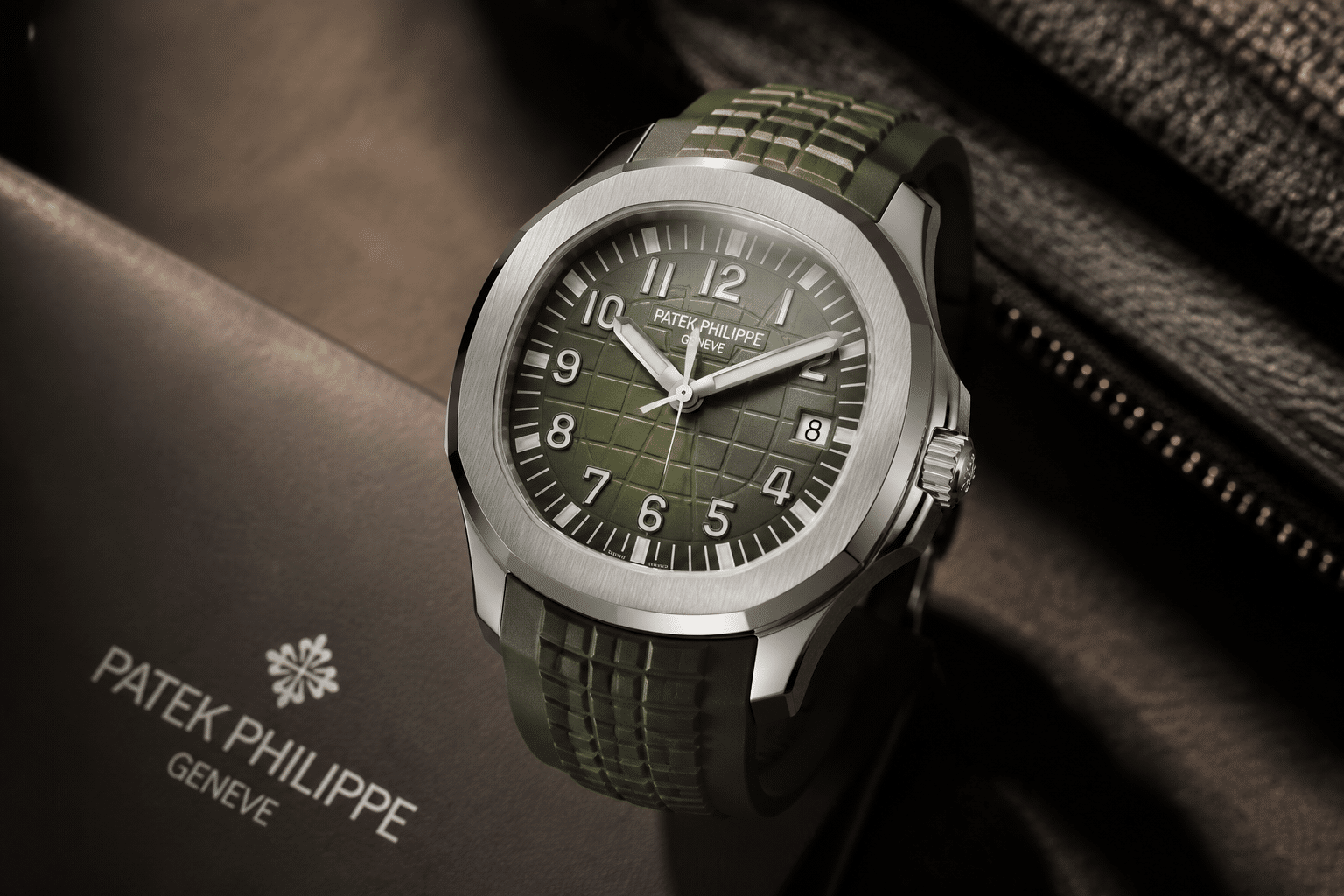 Aquanaut dial under neutral light showing checkerboard depth, surface reflection, and arm’s-length visual presence